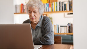 Elderly Lady Working on a Laptop Computer